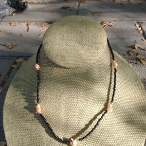 Women's black pink beaded shell necklace.